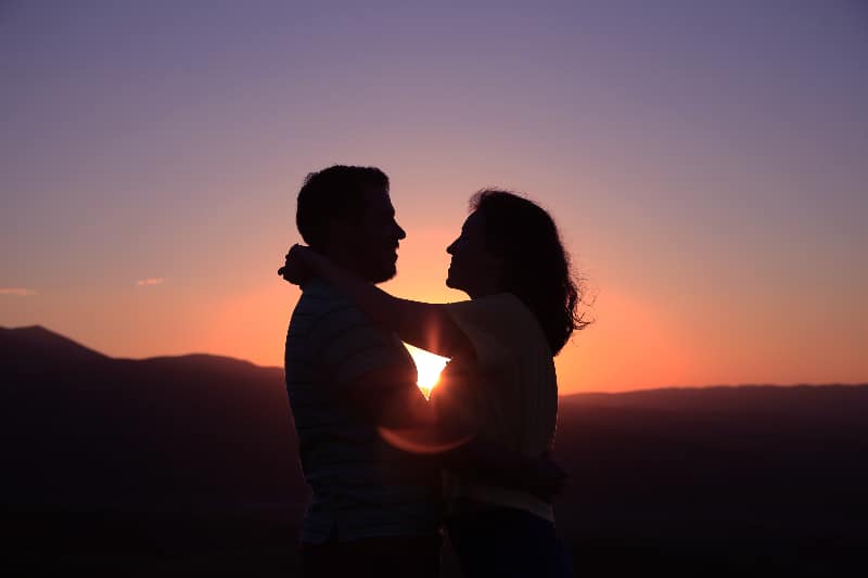 a couple in a sunset showing how to be less selfish in a relationship